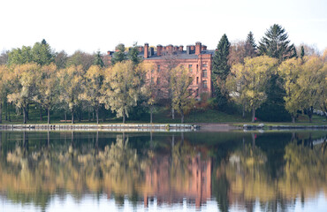 Fototapeta na wymiar Autumn landscape with lake and trees next to a lake