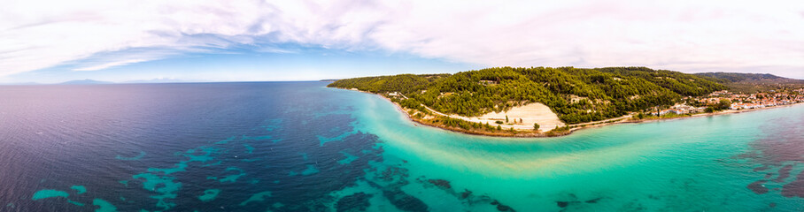 Fototapeta premium Aerial drone view of Fourka Skala sea and pine forest in Halkidiki, Greece