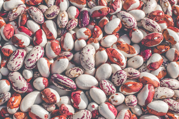 Background of many grains of dried pinto beans. Food background. Close up. Bean background and textured.