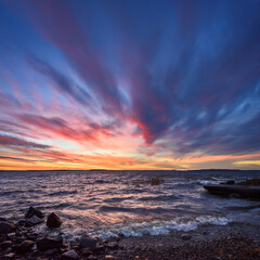 Beautiful dark blue sky of evening beauty and clouds at sunset. Above the horizon the clouds are illuminated by the sun that has hidden behind the horizon.