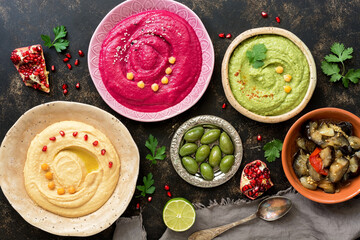 Assorted Middle Eastern hummus. Colored hummus. Arab food. Top view, flat lay.