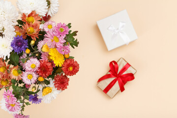 Top view of big bouquet of colorful different flowers and gift boxes..