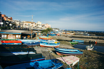 Obraz premium Aci Trezza, Italy, 04 January 2019: a picturesque marina with fishing boats in Aci Trezza, Sicily