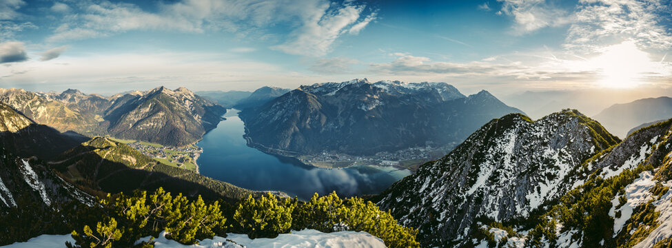 Beautiful panoramic view of the Achensee from Barenkopf rock during sunrise in autumn with dramatic sky.  Tyrol / Austria in it's beauty surrounded with mountains