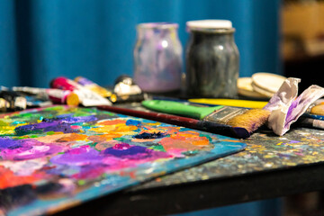 Painter palette with oils and brushes