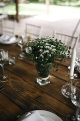 decorated wedding wood table with white chairs