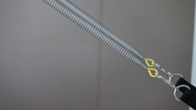 man training on pilates reformer, detail on the legs