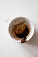 Coffee grounds in white cup on white background isolated top view