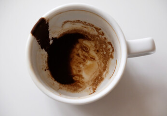 Coffee grounds in white cup on white background isolated top view