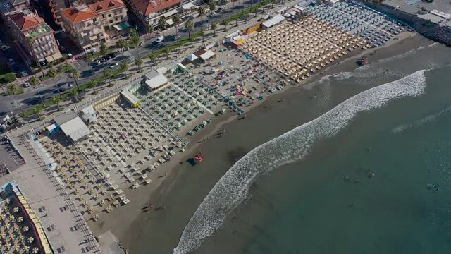 drone descending over a beach in Andora, Liguria