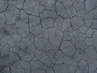 Dry Gray ground covered with crackles . Rusted Background. 
