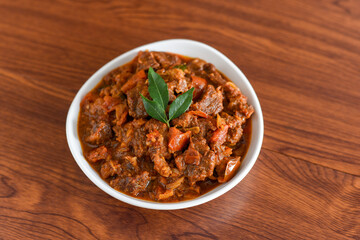 Spicy beef curry. Goan style beef vindaloo. Traditional Indian Lamb or beef curry . spicy Beef curry gravy popular in Kerala Sri Lankan Goa for Appam, Parotta porotta in India.