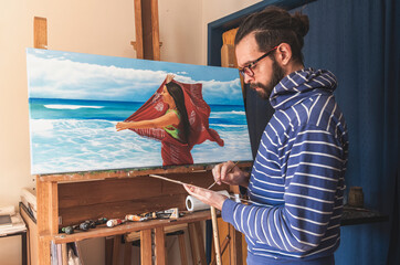 Male artist mixing colours with natural light
