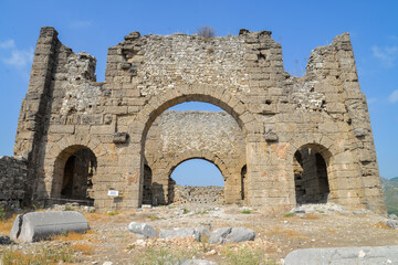 Fototapeta na wymiar Aspendos was an ancient Greco-Roman city in Antalya. Famous historical landmark of Turkey. Founded in the 5th century BC. Great Basilica. Temple, Cisterns, City Square, Nymphaeum, Agora, Market hall.