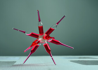 Glass ampoules with a red medicine vaccine glued together in a dim light