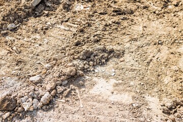 Hard soil with stone from the construction site, environmental and nature concept background, outdoor day light