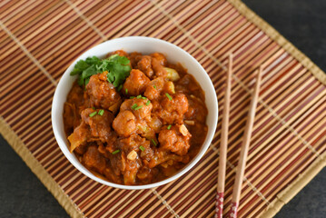 Gobi Manchurian dry and with gravy , Gobi 65 popular street food Delhi India made of cauliflower florets, Veg Manchurian chilly gobi Indo Chinese cuisine side dish of paratha , chapati , roti , Pulao