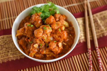 Gobi Manchurian dry and with gravy , Gobi 65 popular street food Delhi India made of cauliflower florets, Veg Manchurian chilly gobi Indo Chinese cuisine side dish of paratha , chapati , roti , Pulao