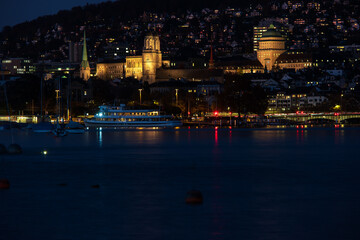Fototapeta premium Zurich city Switzerland late evening blue hour hills in the background lake side view