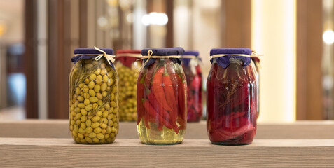 canned vegetables and fruits in glass jars