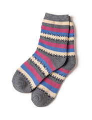 Pair of tall striped socks isolated on a white background. Gray socks with white, blue, pink stripes. warm clothing and hosiery for the cold winter season.