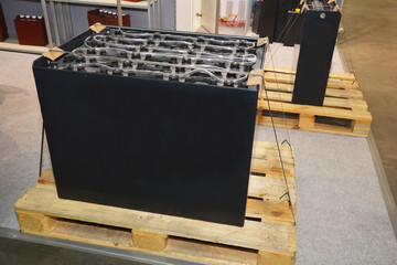 The display of a large motive power, forklift electric battery, accumulator on a wooden pallet,...