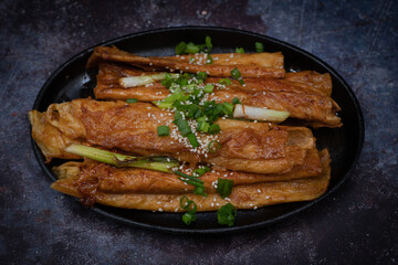 Teriyaki yuba tofu skins ribs on dark plate