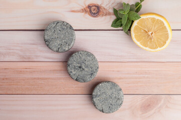 Eco friendly natural solid shampoo and hair conditioner on wooden background. Concept animal fat free, zero waste.