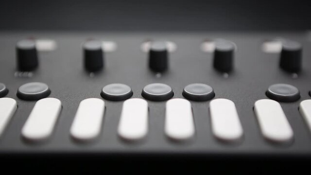 Push buttons and regulators on midi controller synth.professional dj synthesizer device for composing and playing musical tracks on party