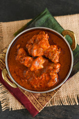 Spicy red chicken curry. Goan style chicken vindaloo. Butter chicken Murgh Makhani curry roast hot and spicy gravy dish Dhaba Punjab, India. North Indian non-vegetarian cuisine Garam Masala. tikka