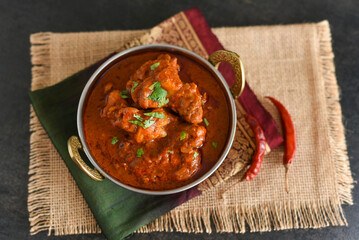 Spicy red chicken curry. Goan style chicken vindaloo. Butter chicken Murgh Makhani curry roast hot and spicy gravy dish Dhaba Punjab, India. North Indian non-vegetarian cuisine Garam Masala. tikka