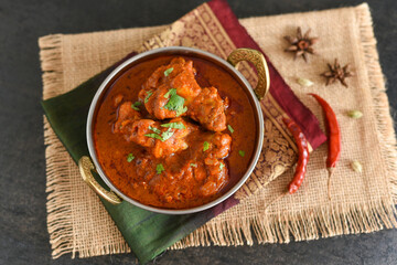 Spicy red chicken curry. Goan style chicken vindaloo. Butter chicken Murgh Makhani curry roast hot and spicy gravy dish Dhaba Punjab, India. North Indian non-vegetarian cuisine Garam Masala. tikka