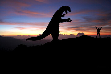 Silhouette eines Godzilla-artigen Monsters und ein Mensch 