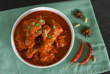 Spicy red chicken curry. Goan style chicken vindaloo. Butter chicken Murgh Makhani curry roast hot and spicy gravy dish Dhaba Punjab, India. North Indian non-vegetarian cuisine Garam Masala. tikka