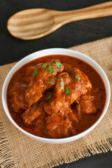 Spicy red chicken curry. Goan style chicken vindaloo. Butter chicken Murgh Makhani curry roast hot and spicy gravy dish Dhaba Punjab, India. North Indian non-vegetarian cuisine Garam Masala. tikka