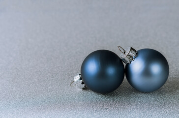 two blue Christmas balls on silver background. christmas composition