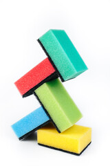 Photo of colorful dishwashing sponge stack on white background.