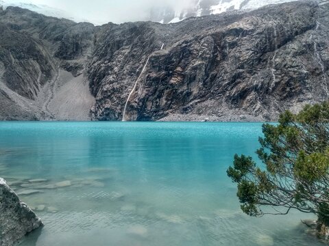 Laguna Paron, Huaraz, Peru. A blue-green lake in the Cordillera Blanca on the Peruvian Andes. At 4185 meters above sea level, it's surrounded by snowy peaks and a pyramid mountain. 