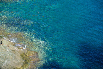 Aerial view of sea waves and fantastic Rocky coast, Italy. Rock and sea. Stone rock close up in the sea water.