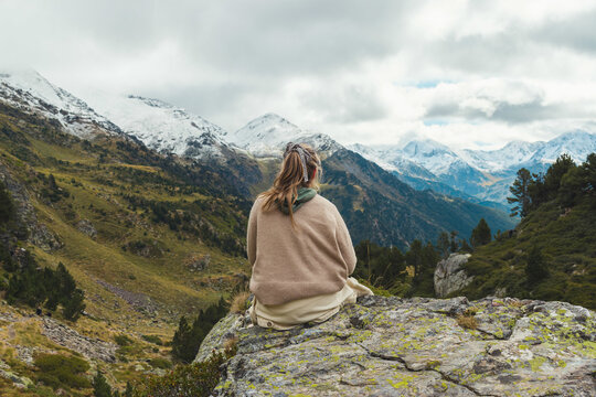 Rear view of a Latina woman sitting on a rock covered in moss Zillertal Valley, Austria