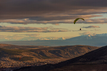 Paraglider against sky with clouds during sunset in Esquel, Patagonia, Argentina