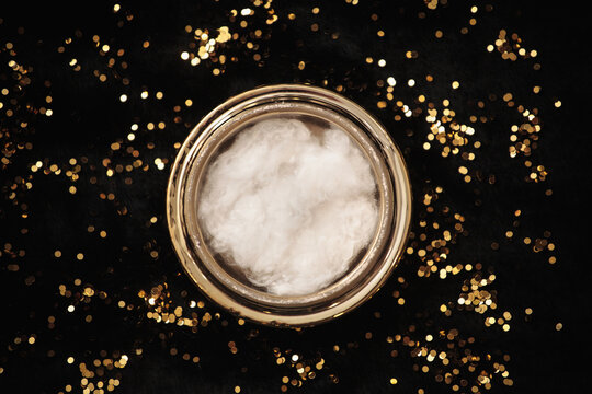 golden bowl on black fur with gold glitter close-up