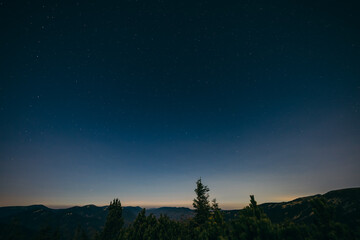 A sign with a mountain in the background