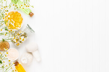 Spa still life with aromatherapy chamomile, herbal oil, soap, sea salt.