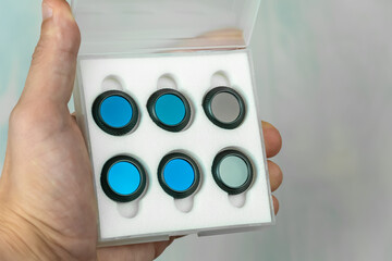 Box with filters for the drone camera in the hand of a man close-up