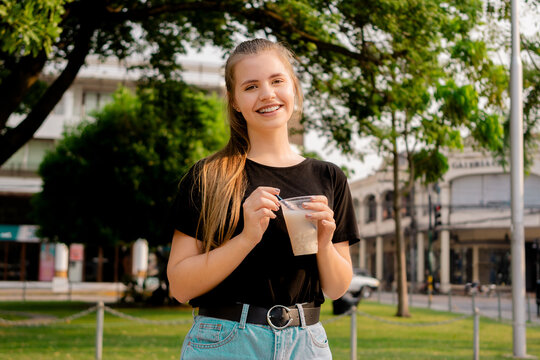 Young beautiful cute Brazilian female drinking Somo, a Bolivian drink