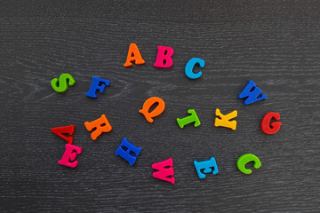 English alphabet on a dark background. Multicolored letters. ABC.