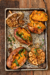 Baked sweet potato and garlic with spices and herbs