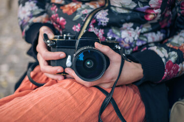 Midsection of woman holding camera