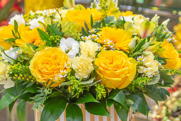 bouquet of yellow roses and white daisies